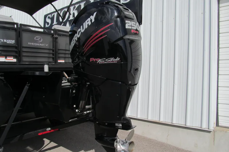 Slide: The Image of 2017 Regency 220 LE3 boat with Mercury 250 Pro outboard motor, parked near a building. - 16