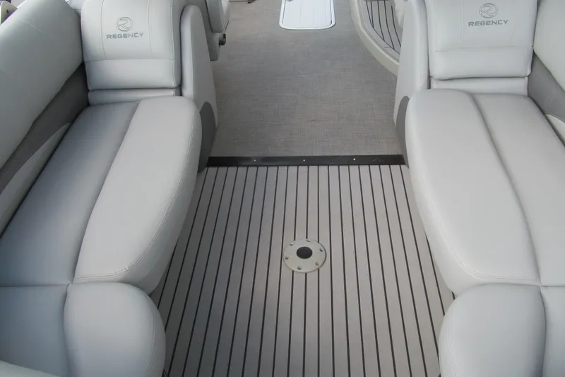 Slide: The Image of 2017 Regency 220 LE3 boat interior with gray seating and striped flooring. - 6