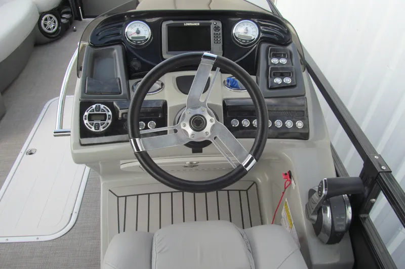 Slide: The Image of 2017 Regency 220 LE3 boat dashboard with steering wheel and control panel. - 8