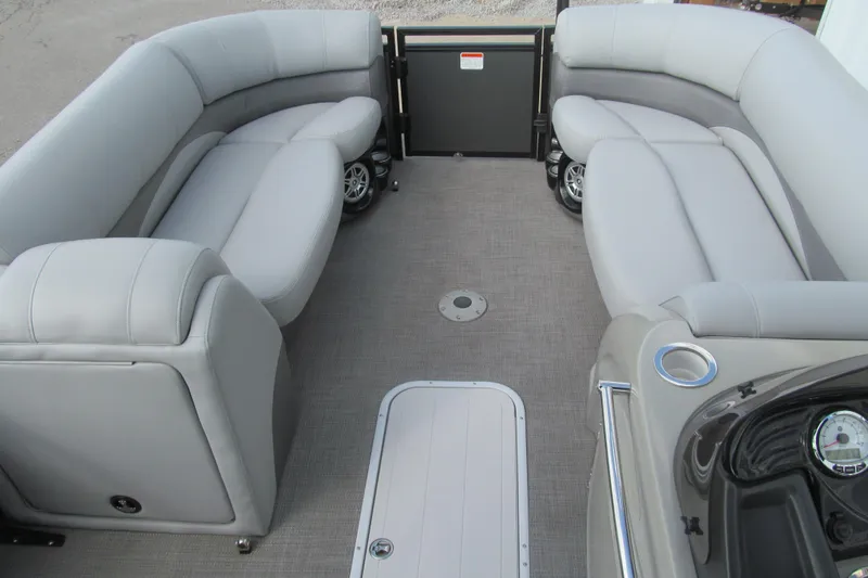 Slide: The Image of Interior of a 2017 Regency 220 LE3 pontoon boat with gray seating and flooring. - 9