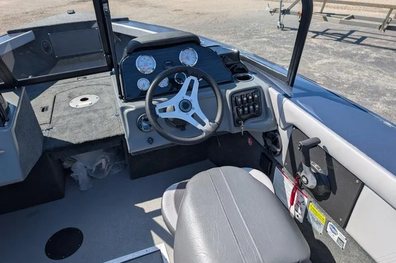 Slide: The Image of 2026 Starcraft Superfisherman 186 boat interior with steering wheel and dashboard controls. - 18