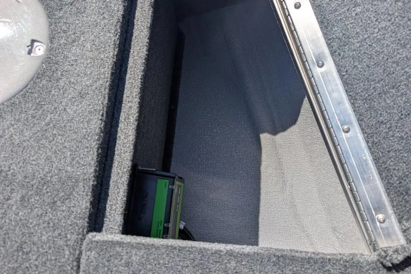 Slide: The Image of Storage compartment in 2026 Starcraft Superfisherman 186 boat, featuring carpeted interior. - 22
