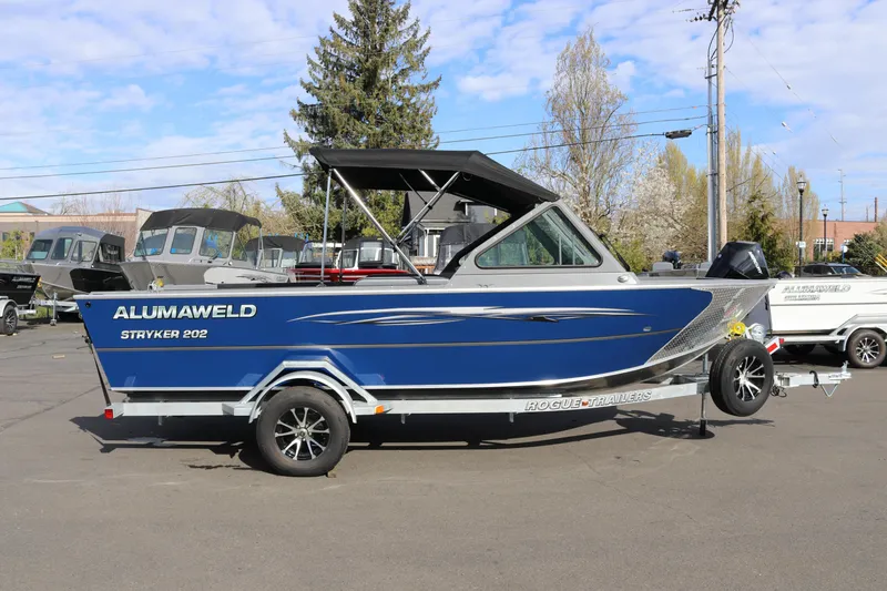 The Image of 2026 Alumaweld Stryker 202 boat on trailer, blue exterior, parked outdoors. - 1