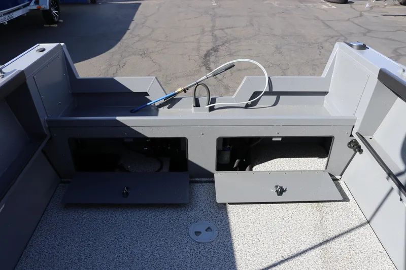Slide: The Image of 2026 Alumaweld Stryker 202 boat interior with storage compartments and hose. - 13
