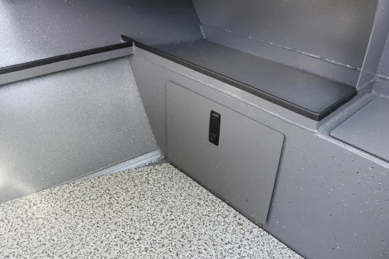 Slide: The Image of Interior of 2026 Alumaweld Stryker 202 boat, featuring storage compartment and speckled flooring. - 26