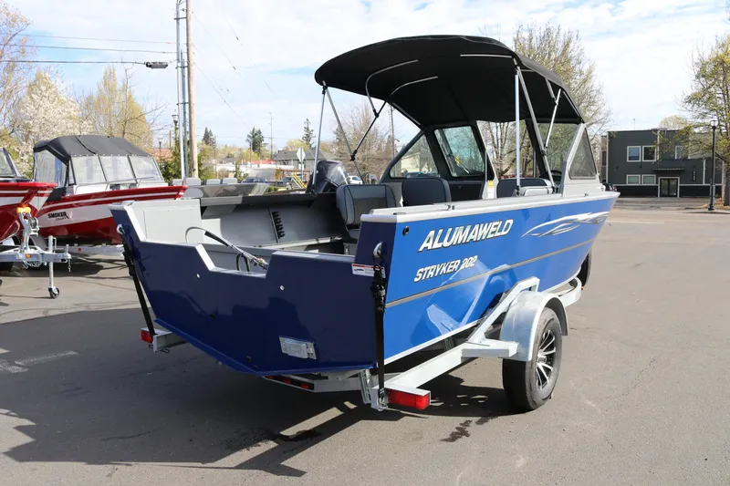 Slide: The Image of 2026 Alumaweld Stryker 202 boat on trailer, blue exterior, parked outdoors. - 29