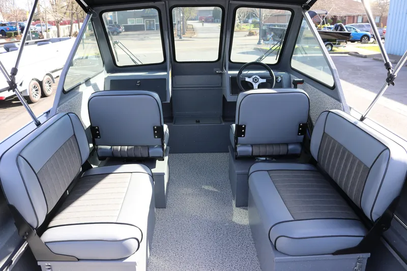 Slide: The Image of Interior of 2026 Alumaweld Stryker 202 boat with gray seating and steering console. - 3
