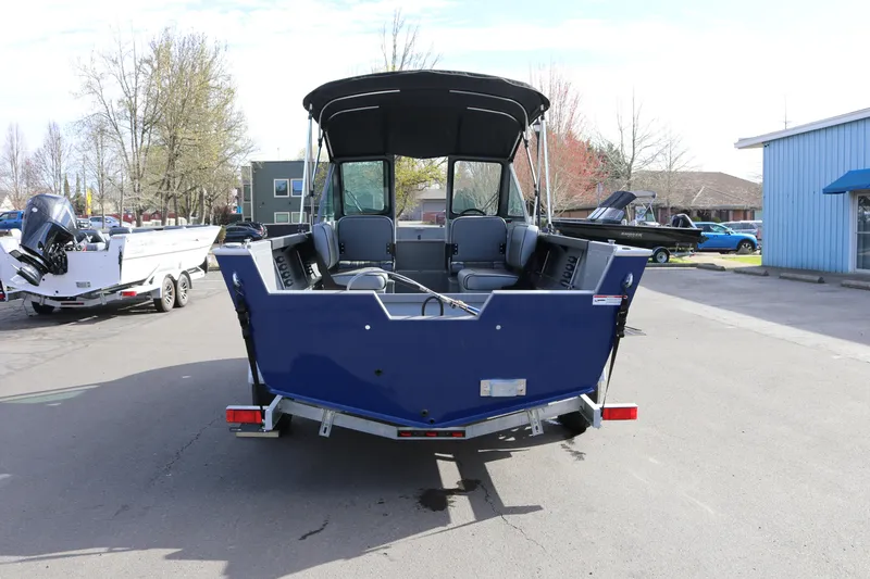 Slide: The Image of 2026 Alumaweld Stryker 202 boat, rear view, parked outdoors on a sunny day. - 30