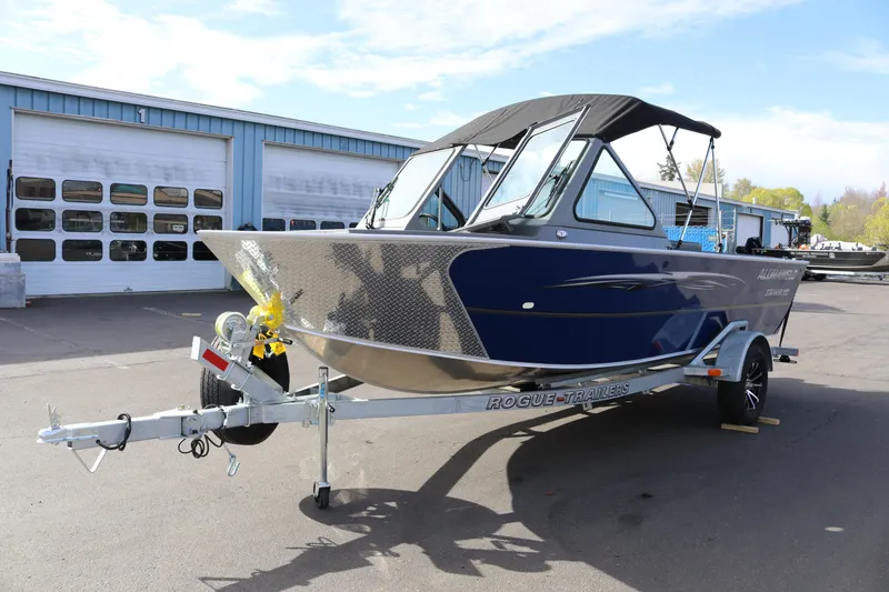 Slide: The Image of 2026 Alumaweld Stryker 202 boat on trailer, parked outside a garage. - 32