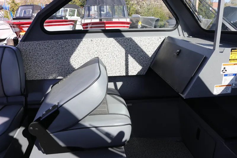 Slide: The Image of Interior of 2026 Alumaweld Stryker 202 boat, featuring gray seating and storage compartment. - 8