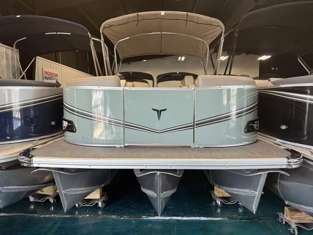 Slide: The Image of 2026 Tahoe LTZ 23 FT Quad Lounger Shift pontoon boat in showroom. - 3