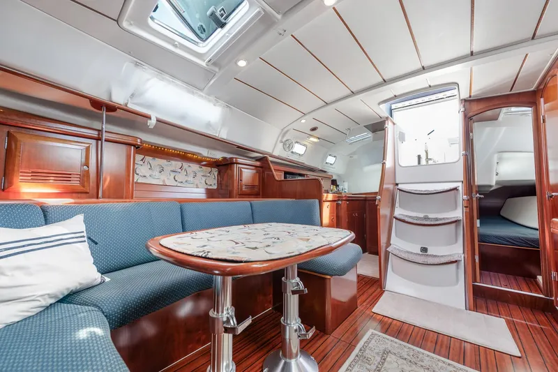 Slide: The Image of Cozy cabin interior of 2003 Beneteau 411 sailboat with nautical-themed decor. - 11