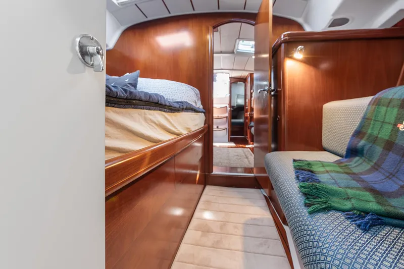 Slide: The Image of Cozy cabin interior of 2003 Beneteau 411 sailboat with wooden finish and bedding. - 13