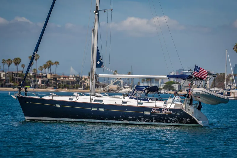 Slide: The Image of Sailboat Beneteau 411 (2003) on water at sunset with vibrant sky. - 2
