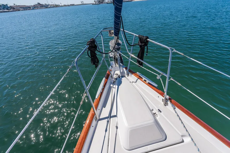 Slide: The Image of 2003 Beneteau 411 sailboat "True Blue" on calm waters, clear sky, coastal view. - 21