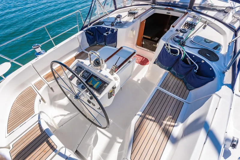 Slide: The Image of Cockpit view of 2003 Beneteau 411 sailboat on calm blue waters. - 26