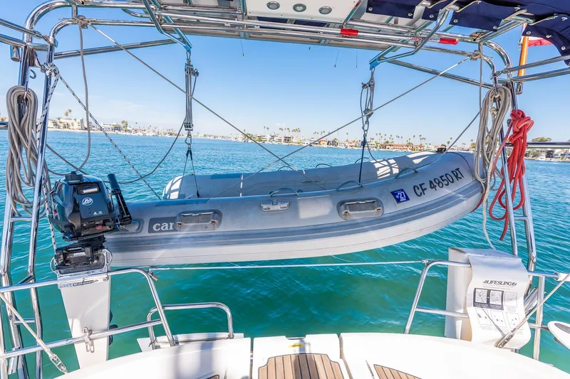 Slide: The Image of 2003 Beneteau 411 sailboat cockpit with blue canopy, sailing on clear blue waters. - 28