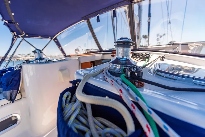Slide: The Image of Cockpit view of 2003 Beneteau 411 sailboat with steering wheel and ocean backdrop. - 32