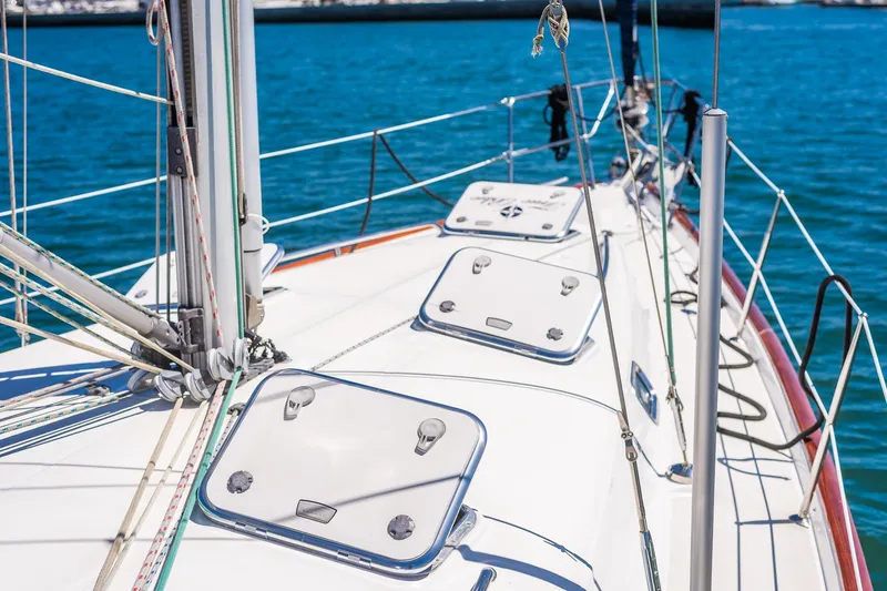 Slide: The Image of 2003 Beneteau 411 sailboat cruising near waterfront homes and palm trees. - 34