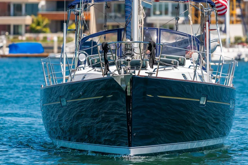 Slide: The Image of 2003 Beneteau 411 sailboat cruising in sunny marina with American flag. - 38