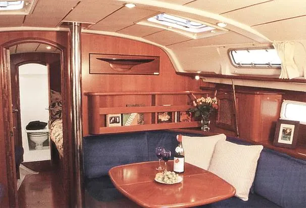 Slide: The Image of Interior of 2003 Beneteau 411 yacht kitchen with wood cabinetry and modern appliances. - 4