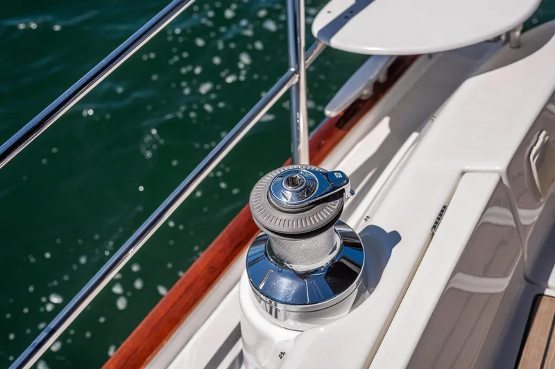 Slide: The Image of Engine compartment of a 2003 Beneteau 411 sailboat, showcasing mechanical components and battery. - 46