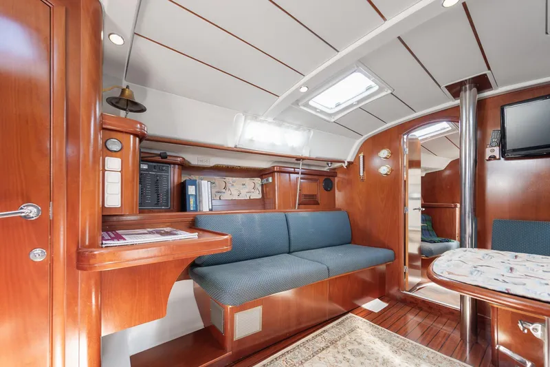 Slide: The Image of Luxurious interior of 2003 Beneteau 411 yacht with cozy seating and elegant wood finish. - 9