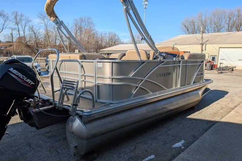 Slide: The Image of 2023 Sylvan Mirage 818 Cruise pontoon boat with Mercury outboard motor, parked outdoors. - 3