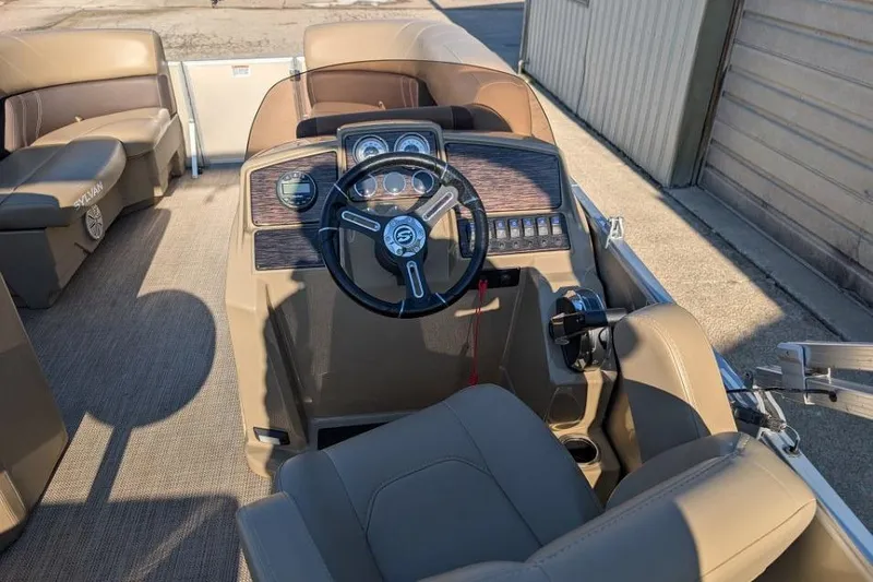Slide: The Image of 2023 Sylvan Mirage 818 Cruise boat interior with steering console and seating. - 4