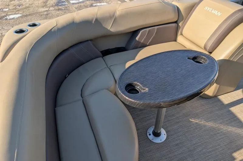 Slide: The Image of 2023 Sylvan Mirage 818 Cruise boat interior with beige seating and a round table. - 5