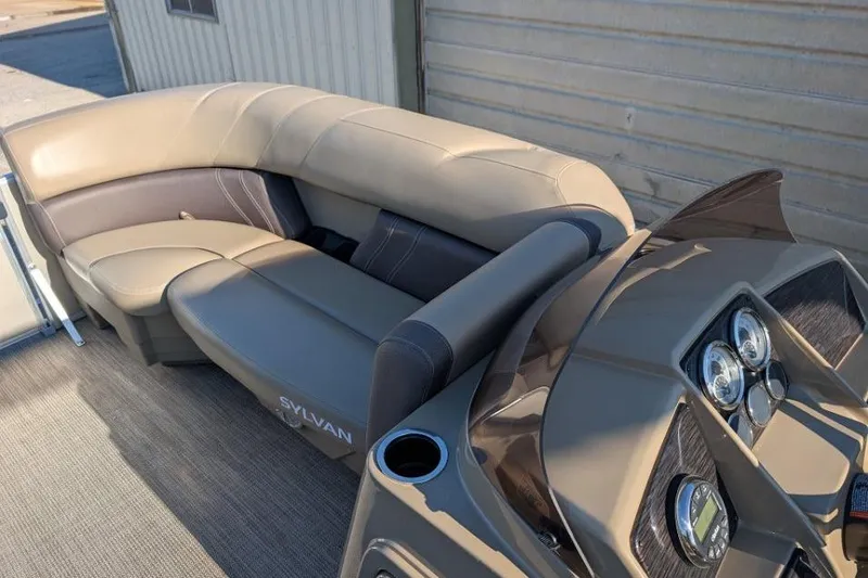 Slide: The Image of 2023 Sylvan Mirage 818 Cruise boat interior with beige seating and dashboard. - 7