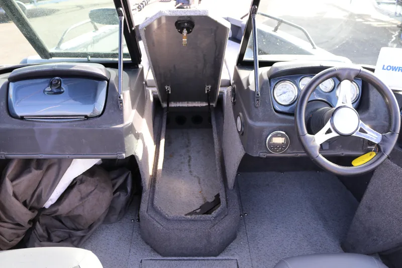 Slide: The Image of 2017 Lowe Fish & Ski 175 boat interior with steering wheel and dashboard controls. - 11