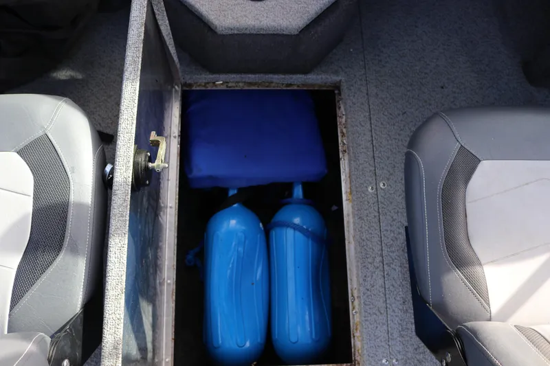 Slide: The Image of Storage compartment in a 2017 Lowe Fish & Ski 175 boat with blue fenders. - 12
