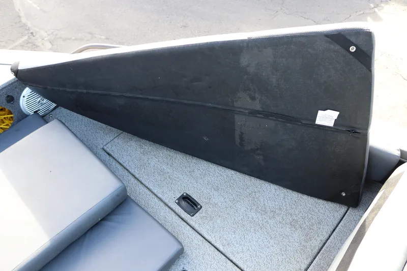 Slide: The Image of 2017 Lowe Fish & Ski 175 boat interior with seating and storage compartment. - 14