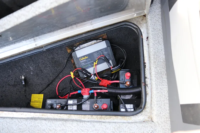 Slide: The Image of Battery compartment of 2017 Lowe Fish & Ski 175 boat with charger and wiring. - 15