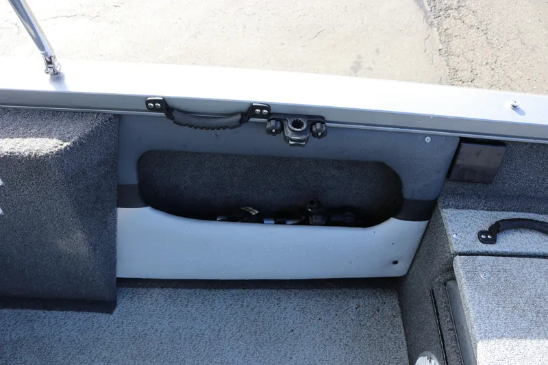 Slide: The Image of Interior view of a 2017 Lowe Fish & Ski 175 boat, showing storage compartment. - 16