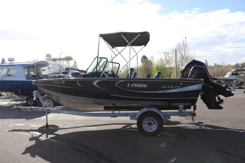 Slide: The Image of 2017 Lowe Fish & Ski 175 boat on trailer, parked outdoors. - 18