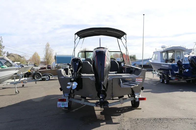 Slide: The Image of 2017 Lowe Fish & Ski 175 boat on trailer, rear view in a marina setting. - 20