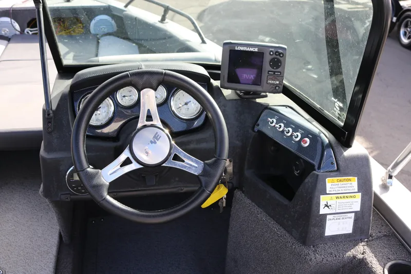 Slide: The Image of 2017 Lowe Fish & Ski 175 boat dashboard with steering wheel and navigation system. - 7