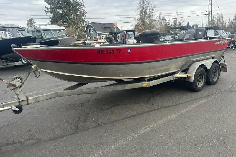 The Image of 1992 Alumaweld Super Vee Mechanic's Special boat on trailer, red and silver exterior. - 1