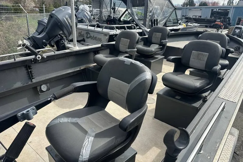 Slide: The Image of 1992 Alumaweld Super Vee boat interior with multiple cushioned seats and Yamaha outboard motors. - 5