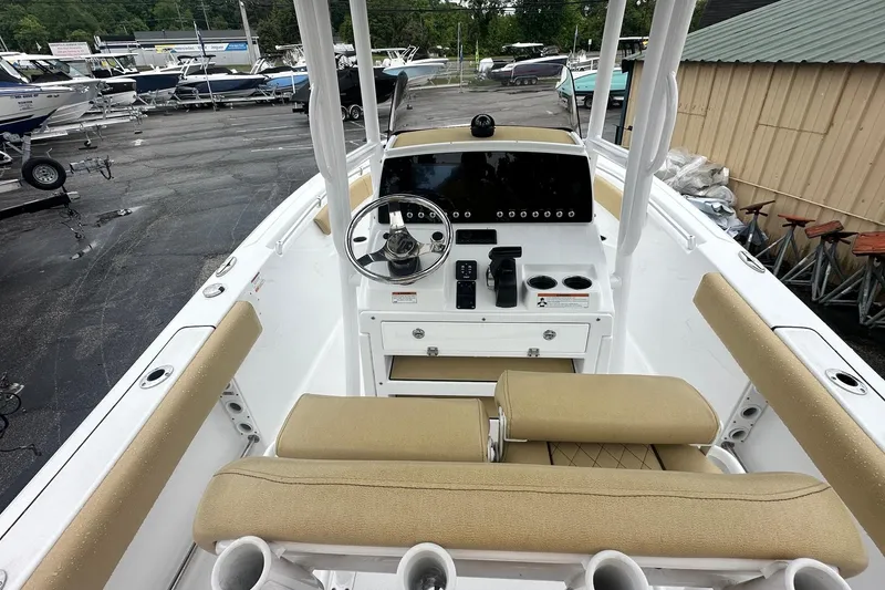Slide: The Image of 2022 Sportsman Open 212 Center Console boat interior with steering wheel and seating. - 16