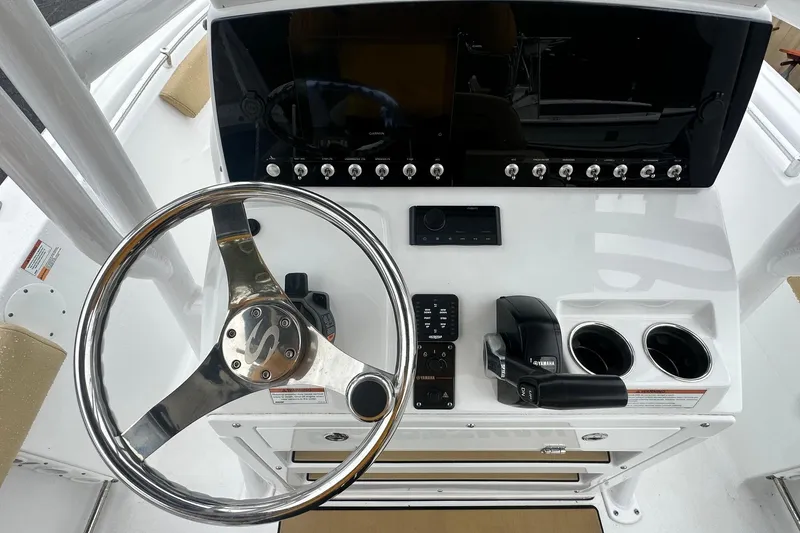 Slide: The Image of 2022 Sportsman Open 212 Center Console dashboard with steering wheel and controls. - 19