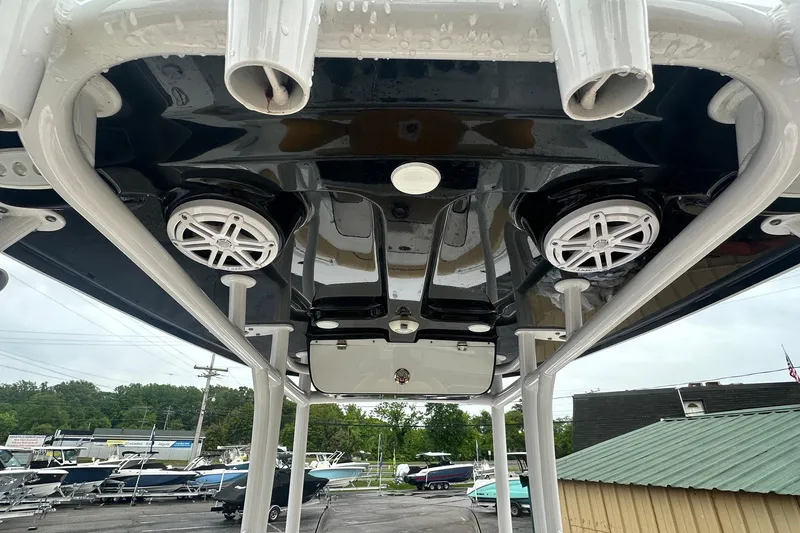 Slide: The Image of 2022 Sportsman Open 212 Center Console boat with speakers and rod holders on the T-top. - 22