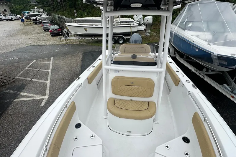 Slide: The Image of 2022 Sportsman Open 212 Center Console boat with tan seating, docked in a marina. - 23
