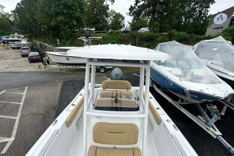 Slide: The Image of 2022 Sportsman Open 212 Center Console boat in a marina, surrounded by other boats. - 25