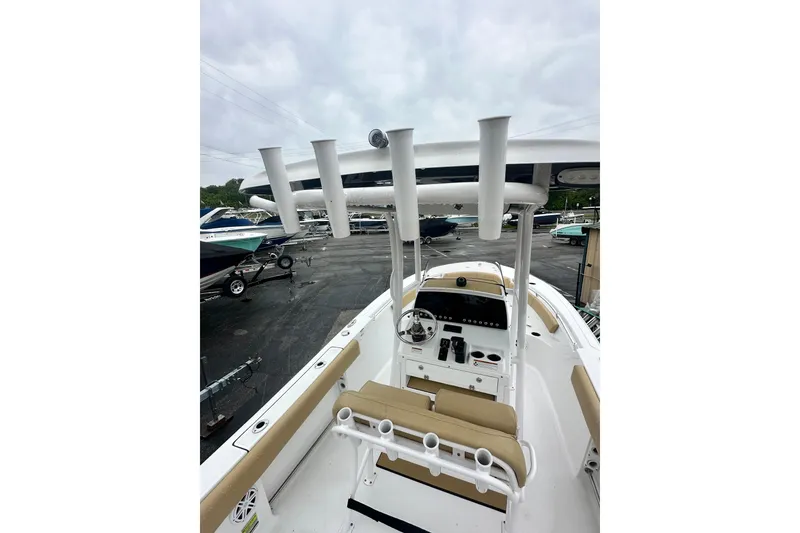 Slide: The Image of 2022 Sportsman Open 212 Center Console boat with beige seating and rod holders. - 26