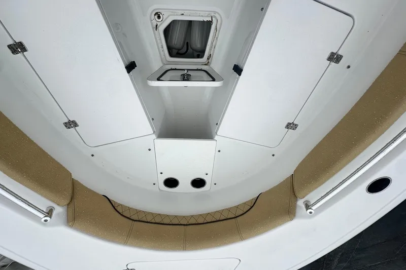 Slide: The Image of 2022 Sportsman Open 212 Center Console boat interior with storage compartments and cushioned seating. - 28
