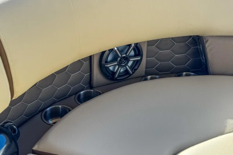 Slide: The Image of 2026 Veranda VR235L boat interior with speaker, cup holders, and hexagonal pattern upholstery. - 12