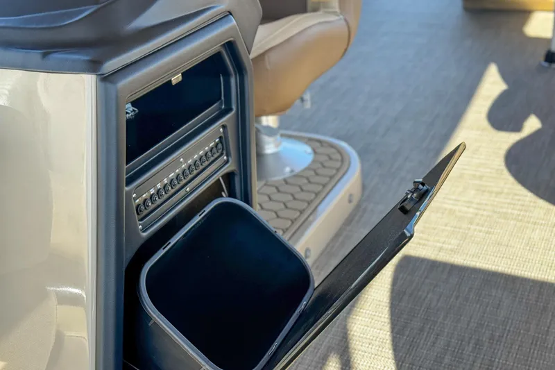 Slide: The Image of 2026 Veranda VR235L boat interior with open storage compartment and control panel. - 13